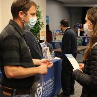 Student holds 2021 Majors Fair information sheet